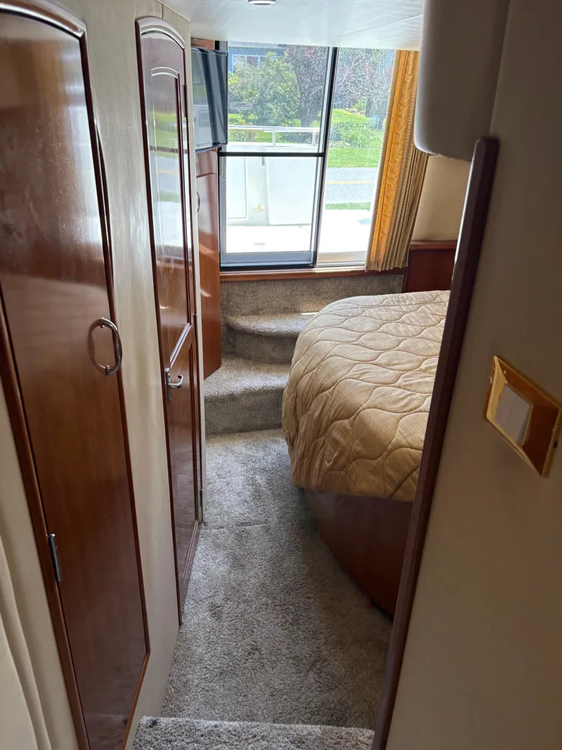 Slide: The Image of Interior of 2005 Carver 44 CPMY yacht with cozy bedroom and large window. - 22