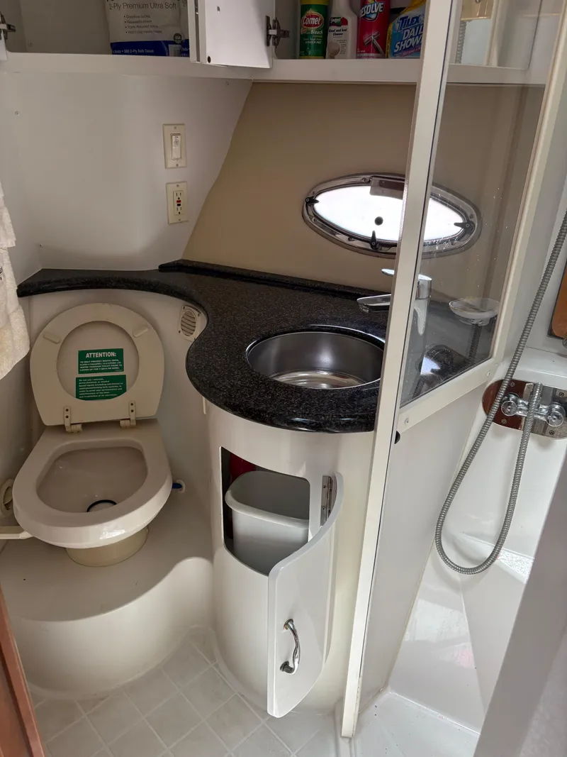 Slide: The Image of 2005 Carver 44 CPMY yacht bathroom with toilet, sink, and shower. - 29