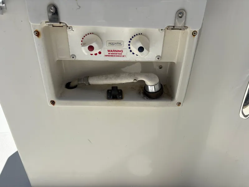 Slide: The Image of 2005 Carver 44 CPMY boat shower controls with hot and cold water knobs. - 3