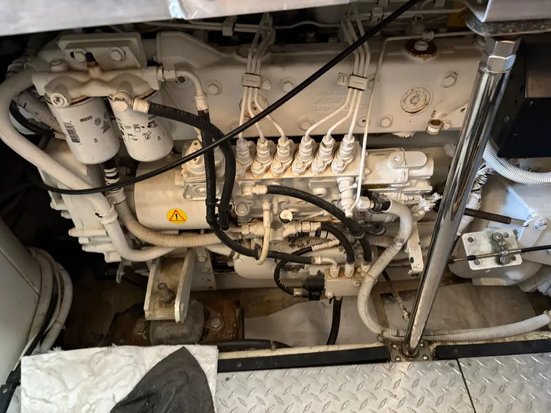 Slide: The Image of Engine compartment of a 2005 Carver 44 CPMY yacht, showcasing mechanical components and wiring. - 30