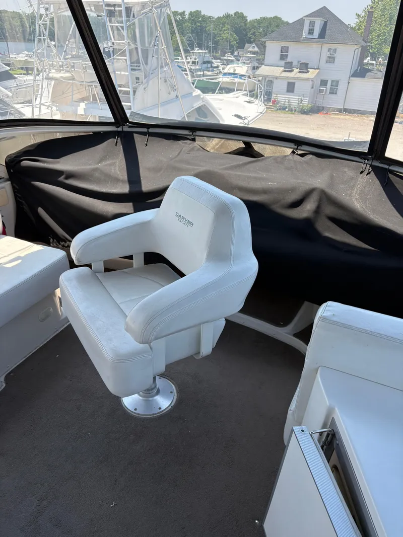 Slide: The Image of Captain's chair on 2005 Carver 44 CPMY yacht, with marina view in background. - 10