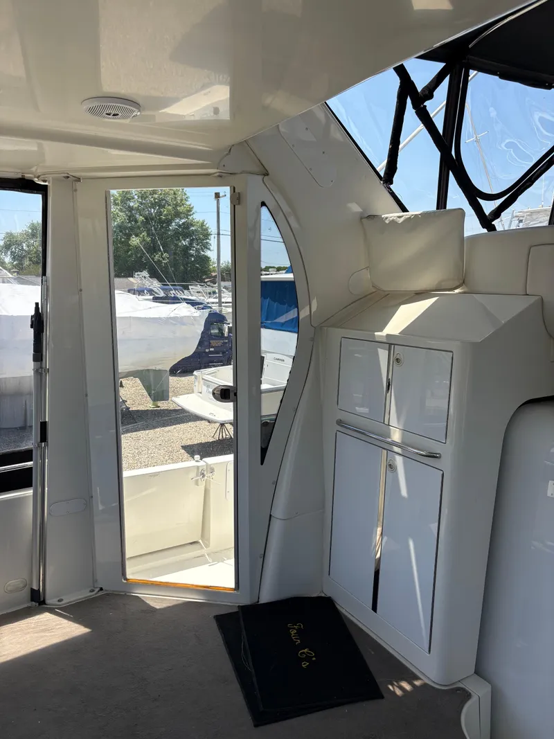 Slide: The Image of Interior view of 2005 Carver 44 CPMY yacht, featuring sleek cabinetry and large windows. - 13