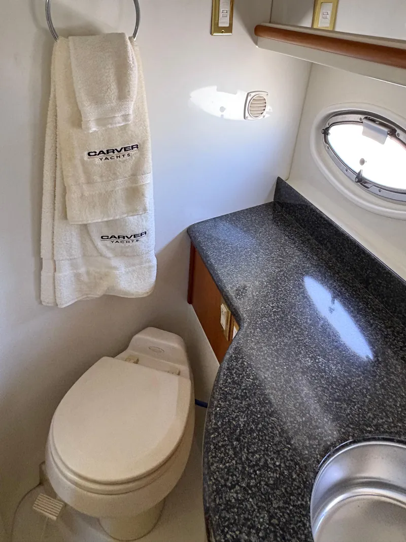 Slide: The Image of 2005 Carver 44 CPMY yacht bathroom with granite countertop and branded towels. - 26