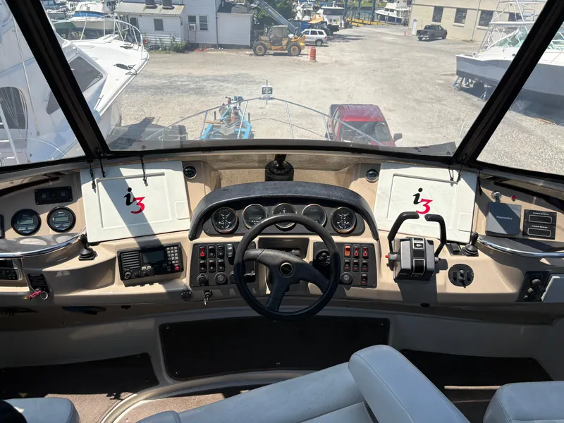 Slide: The Image of Helm of 2005 Carver 44 CPMY yacht with steering wheel and control panels. - 8