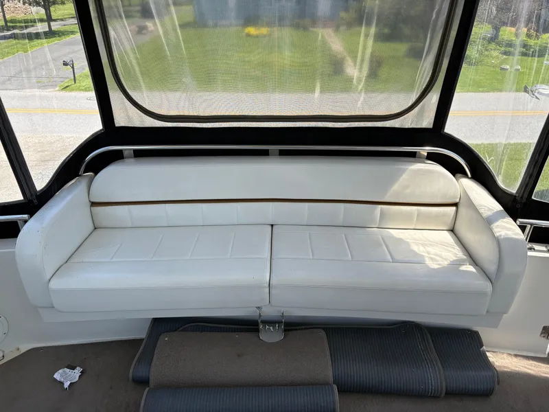 Slide: The Image of 2005 Carver 44 CPMY yacht interior with white leather seating and large windows. - 14