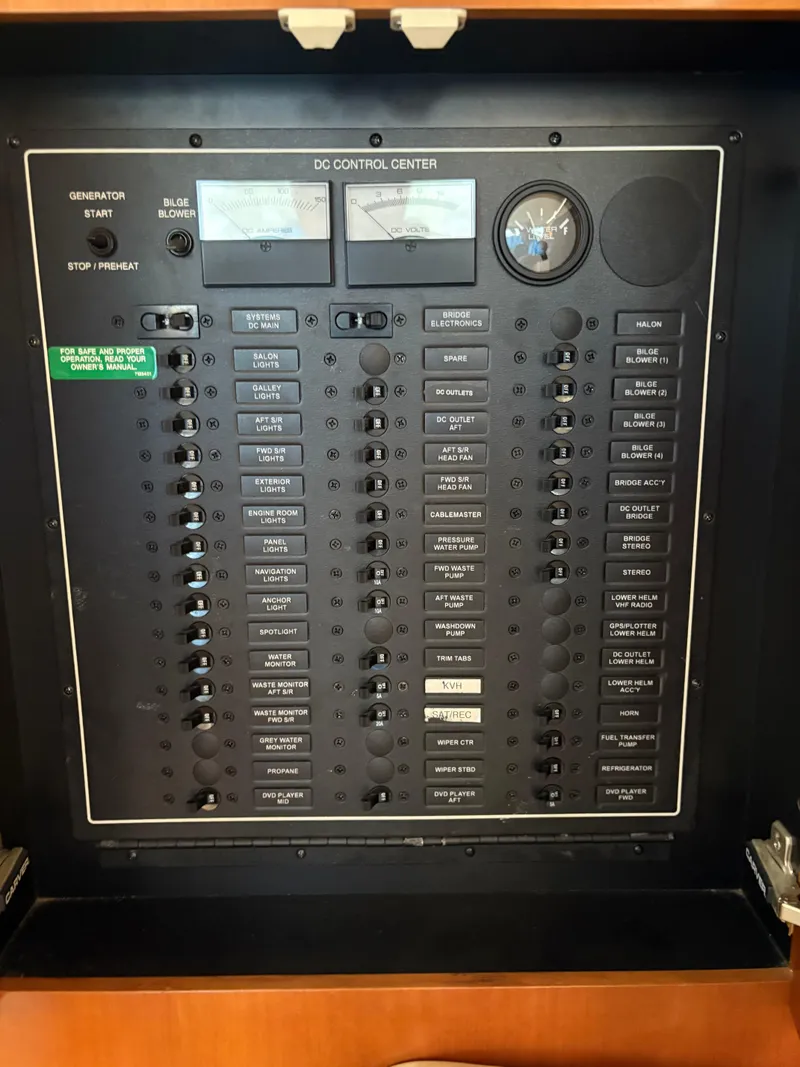 Slide: The Image of Control panel of a 2005 Carver 44 CPMY boat, featuring various switches and gauges. - 15