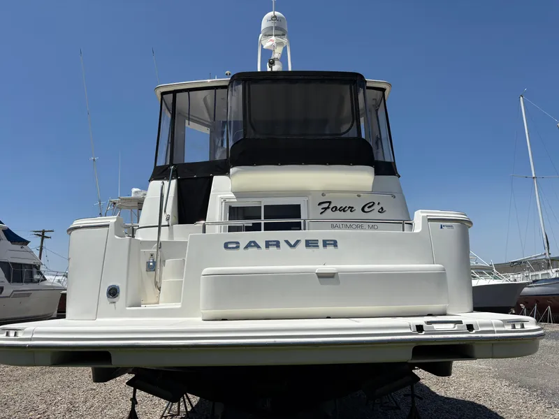 Slide: The Image of 2005 Carver 44 CPMY yacht, rear view, docked under clear blue sky. - 2