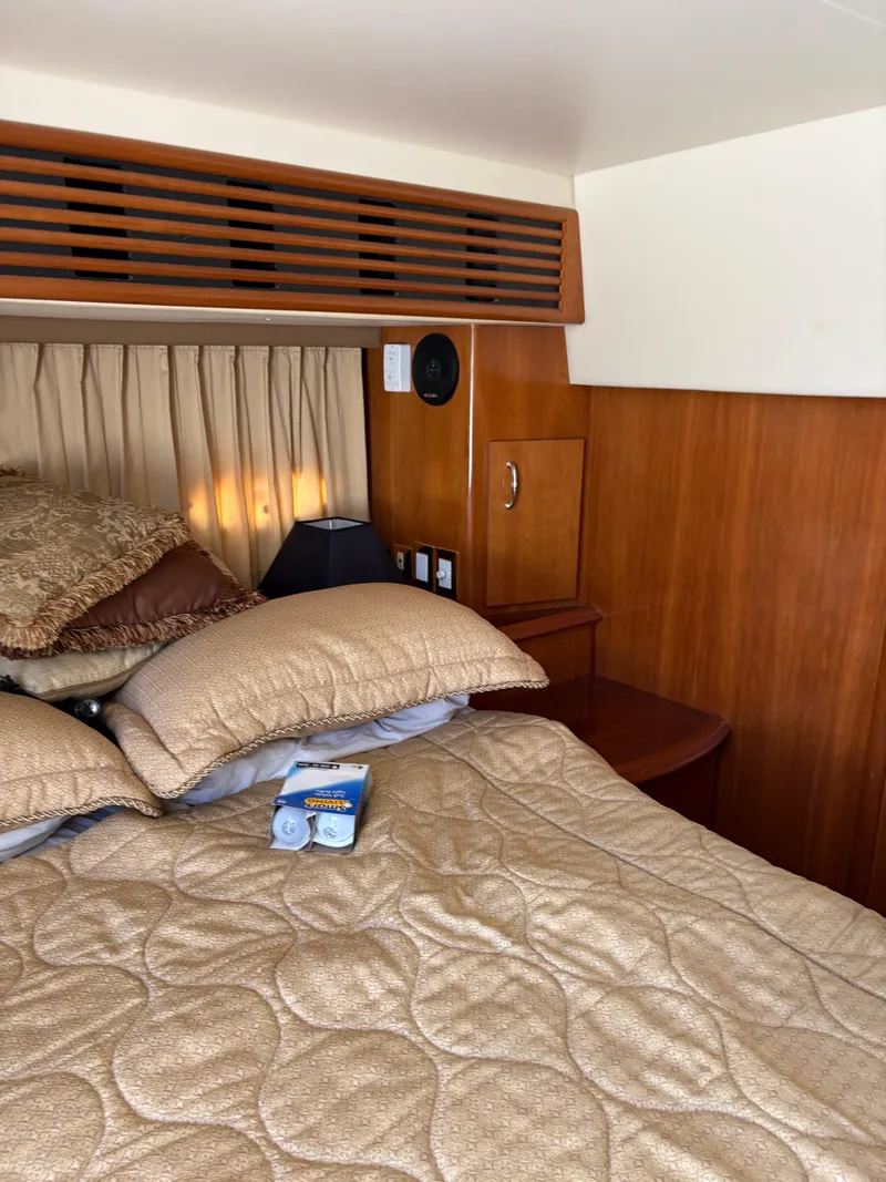 Slide: The Image of Luxurious cabin interior of a 2005 Carver 44 CPMY yacht with plush bedding. - 23