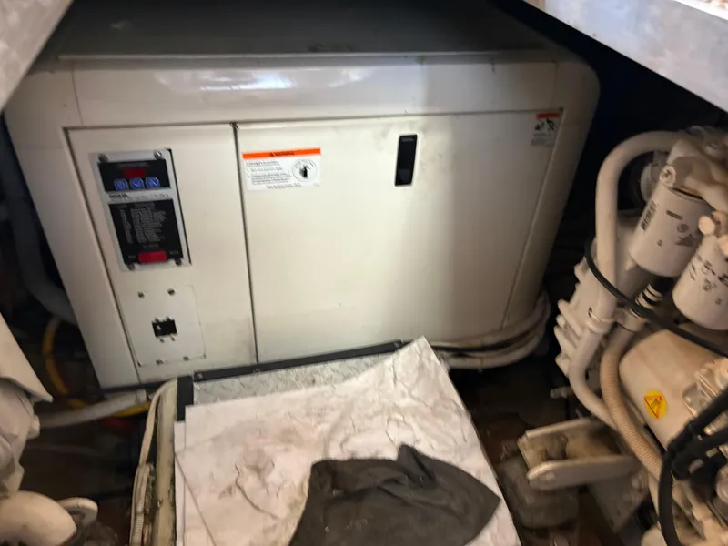 Slide: The Image of Engine room of 2005 Carver 44 CPMY yacht, featuring generator and mechanical components. - 31