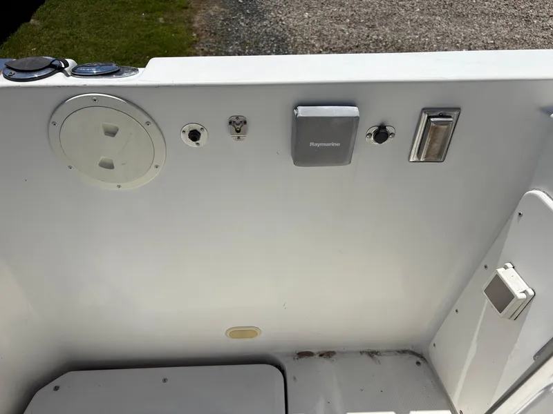 Slide: The Image of 2005 Carver 44 CPMY boat control panel with various switches and Raymarine equipment. - 4