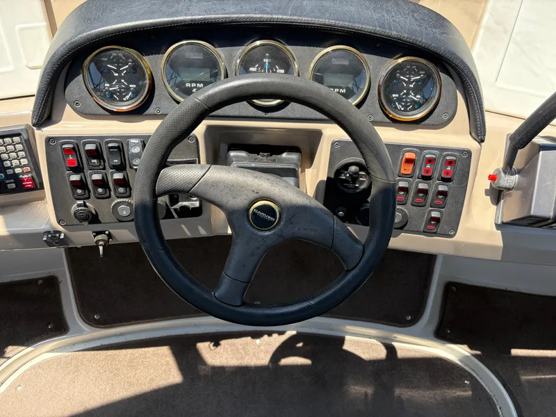 Slide: The Image of Steering wheel and dashboard of 2005 Carver 44 CPMY boat with gauges and controls. - 6