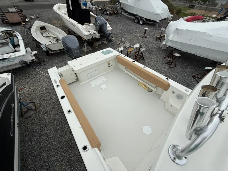 Slide: The Image of 2019 Parker 2320 Sport Cabin boat in storage yard, surrounded by other boats. - 14