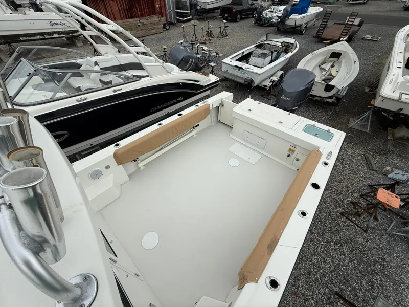 Slide: The Image of 2019 Parker 2320 Sport Cabin boat in a marina, surrounded by other vessels. - 15