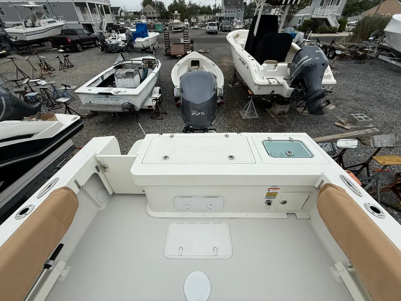 Slide: The Image of 2019 Parker 2320 Sport Cabin boat in a marina with other vessels. - 18