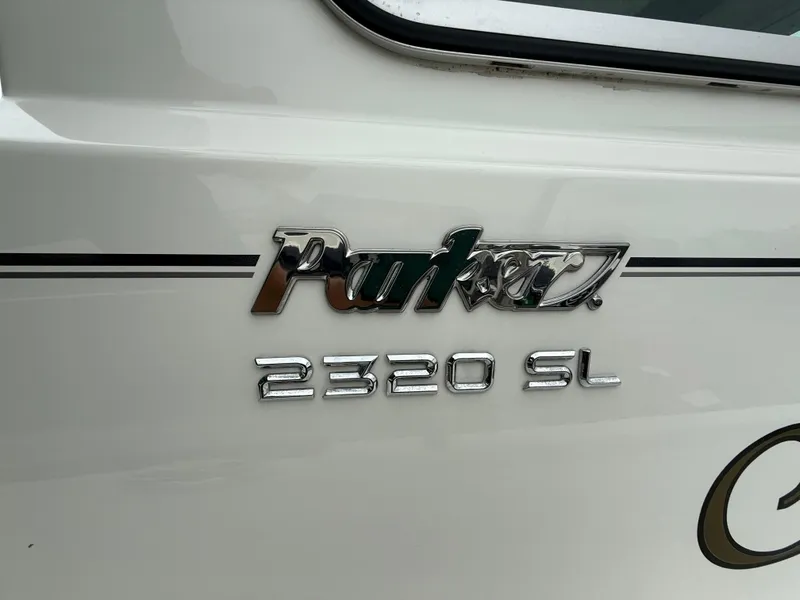 Slide: The Image of Chrome logo on 2019 Parker 2320 Sport Cabin boat exterior. - 27