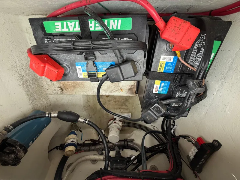 Slide: The Image of Battery compartment of a 2019 Parker 2320 Sport Cabin boat with wiring and connectors. - 28