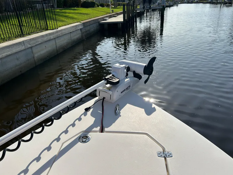 Slide: The Image of Bow of 2019 Pathfinder 2200 CC boat with trolling motor on calm water. - 18