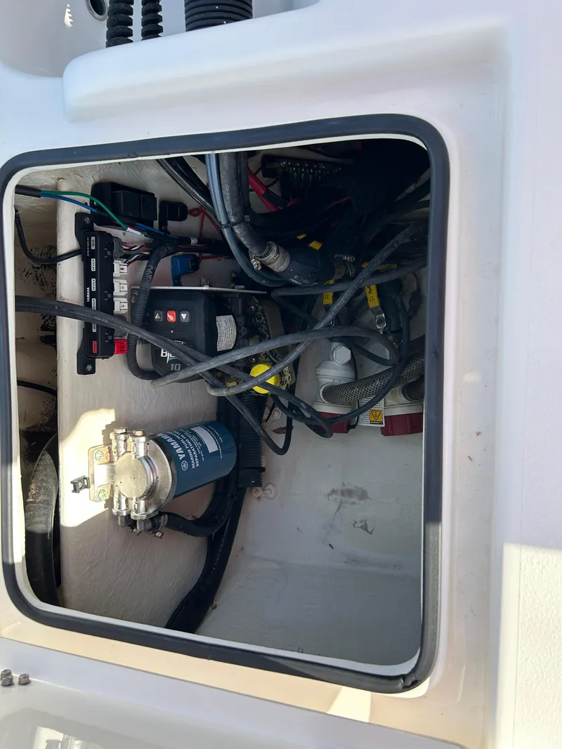 Slide: The Image of 2019 Pathfinder 2200 CC boat wiring and components inside a compartment. - 19