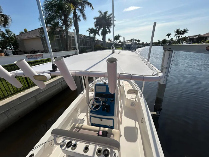 Slide: The Image of 2019 Pathfinder 2200 CC boat docked by a canal with palm trees. - 5