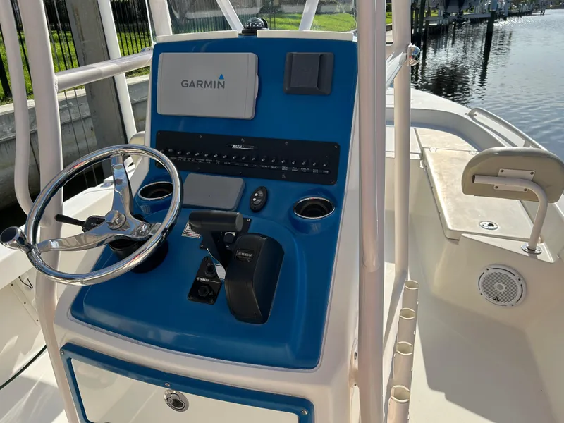 Slide: The Image of 2019 Pathfinder 2200 CC boat console with Garmin navigation system, steering wheel, and controls. - 6