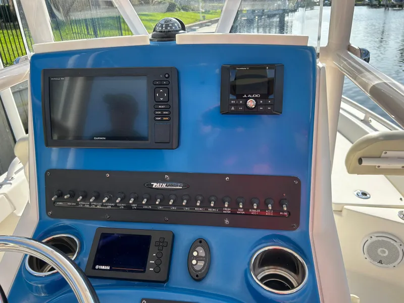Slide: The Image of Control panel of a 2019 Pathfinder 2200 CC boat with navigation and audio systems. - 8