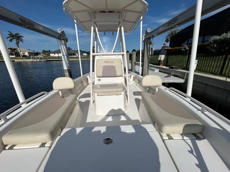 Slide: The Image of 2019 Pathfinder 2200 CC boat with seating, docked by a waterfront home. - 9