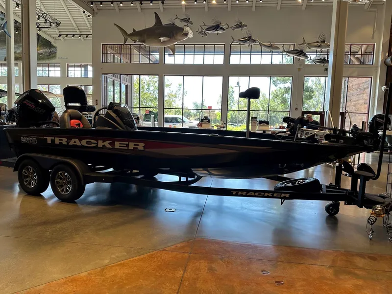 The Image of 2025 Tracker Savage 215 boat displayed indoors with fishing equipment. - 0