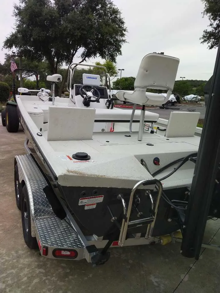 Slide: The Image of 2025 Ranger RB210 boat on trailer, featuring a spacious deck and seating. - 4