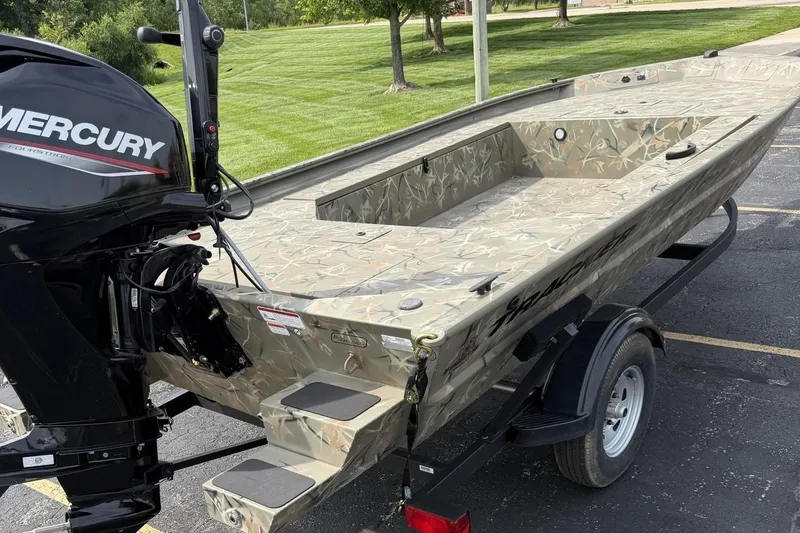 Slide: The Image of 2025 Tracker Grizzly 1654 T Sportsman boat with Mercury engine on trailer. - 2