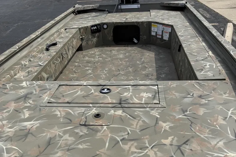 Slide: The Image of 2025 Tracker Grizzly 1654 T Sportsman boat interior with camouflage design. - 4