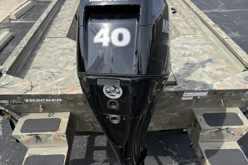 Slide: The Image of 2025 Tracker Grizzly 1654 T Sportsman boat with camo design and Mercury 40 outboard motor. - 6