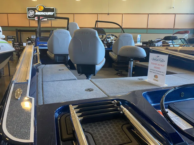 Slide: The Image of 2025 Nitro ZV20 Pro boat interior with seating and a caution sign in a showroom. - 3