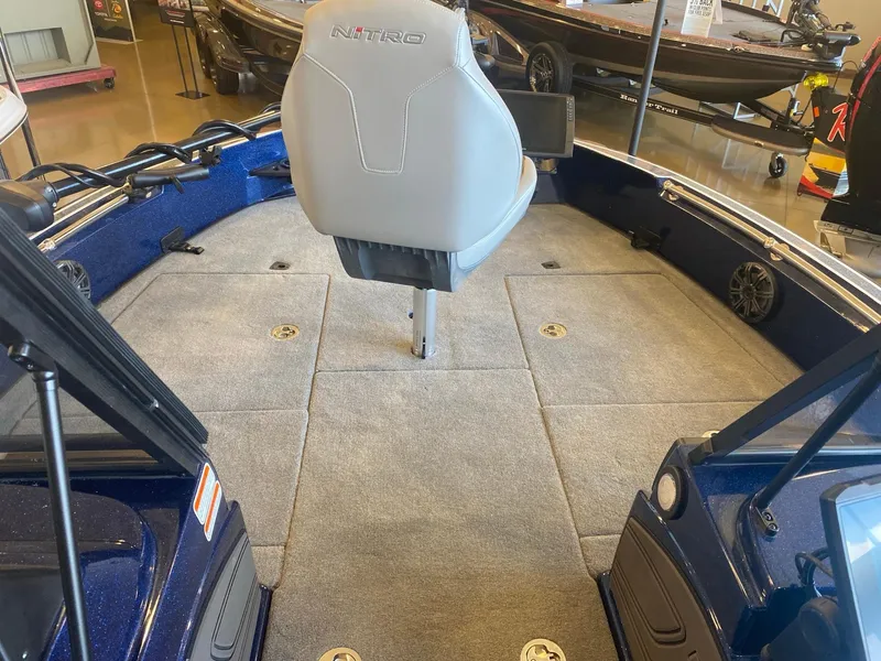 Slide: The Image of 2025 Nitro ZV20 Pro boat interior with gray seating and carpeted deck. - 7