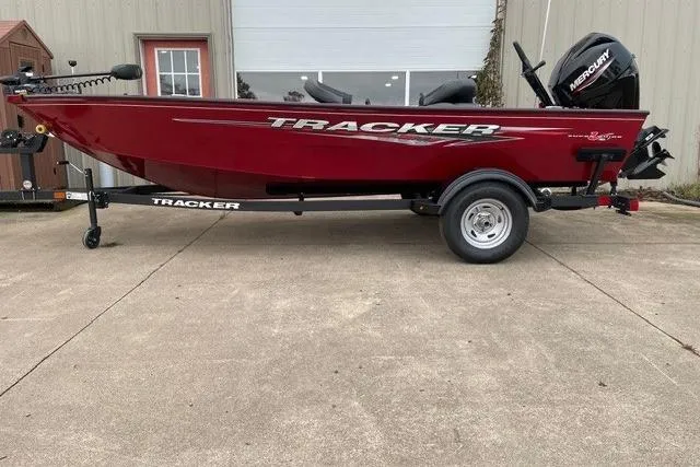 The Image of 2025 Tracker Super Guide V-16 T boat, red, on trailer, parked outdoors. - 0
