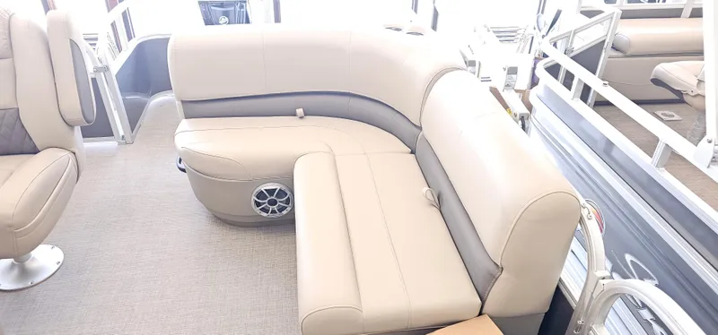 Slide: The Image of 2025 Sun Tracker Party Barge 18 DLX interior with beige seating and speaker system. - 12