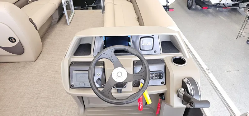 Slide: The Image of 2025 Sun Tracker Party Barge 18 DLX helm with steering wheel and control panel. - 8