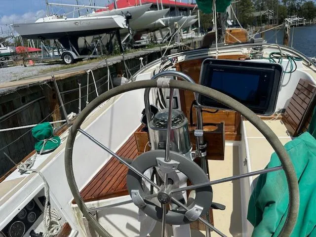 Slide: The Image of 1978 Tartan 37 sailboat cockpit with steering wheel and navigation equipment. - 12
