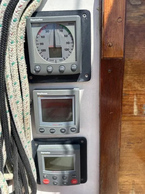 Slide: The Image of Sailing instruments on a 1978 Tartan 37 yacht, featuring Raymarine displays and nautical ropes. - 13