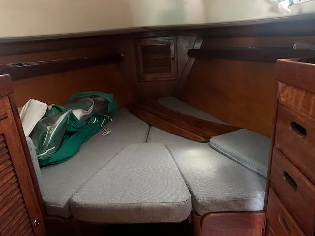 Slide: The Image of Cozy cabin interior of 1978 Tartan 37 sailboat with wooden finish and cushioned seating. - 8