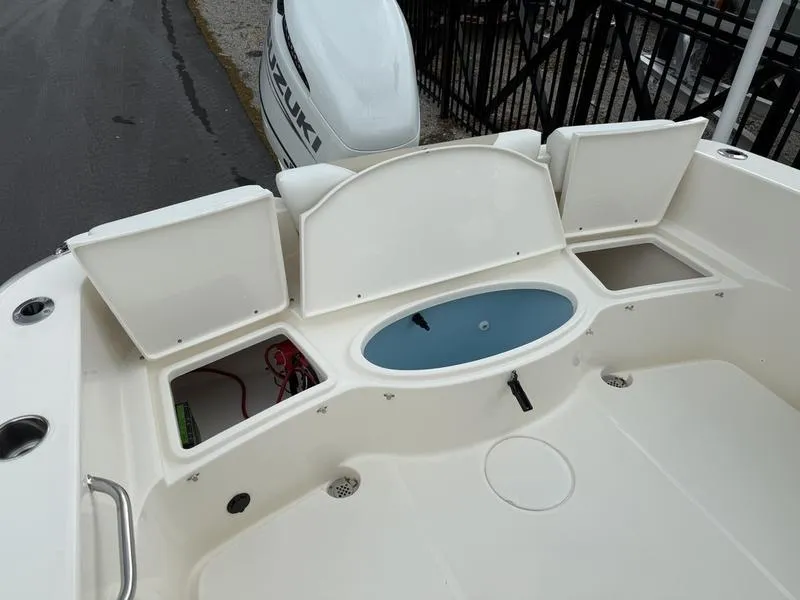 Slide: The Image of 2025 Bulls Bay 230 Center Console boat with open storage compartments and Suzuki outboard motor. - 12