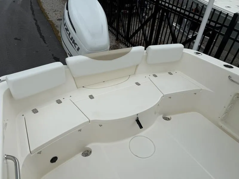 Slide: The Image of 2025 Bulls Bay 230 Center Console boat interior with seating and storage compartments. - 13