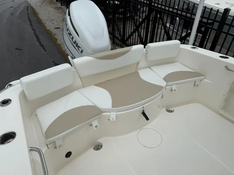 Slide: The Image of 2025 Bulls Bay 230 Center Console boat with cushioned seating and Suzuki outboard motor. - 14