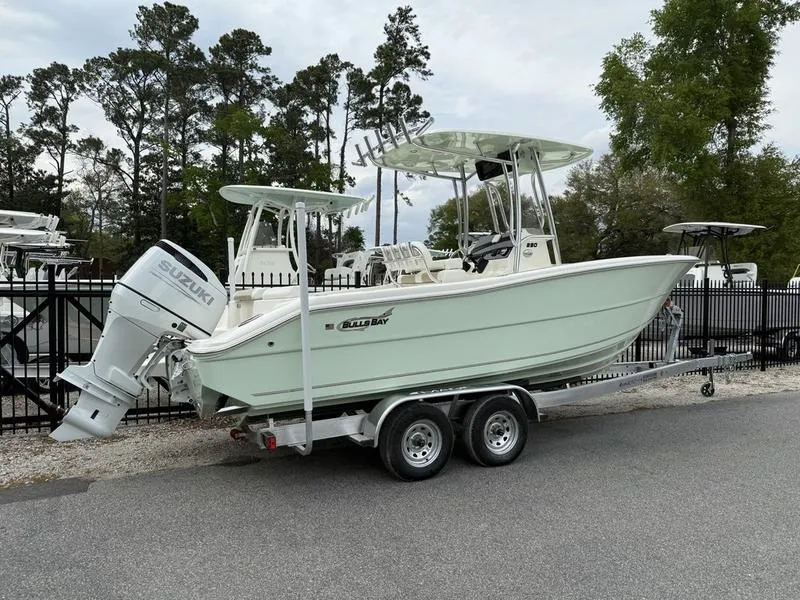 Slide: The Image of 2025 Bulls Bay 230 Center Console boat on trailer, parked outdoors. - 2