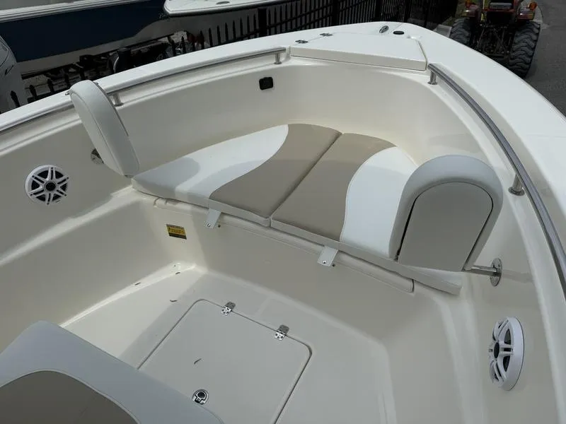 Slide: The Image of 2025 Bulls Bay 230 Center Console boat interior with cushioned seating and storage compartments. - 4