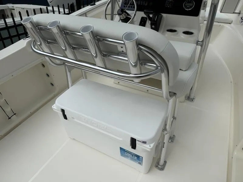 Slide: The Image of 2025 Bulls Bay 230 Center Console boat interior with rod holders and cooler. - 9