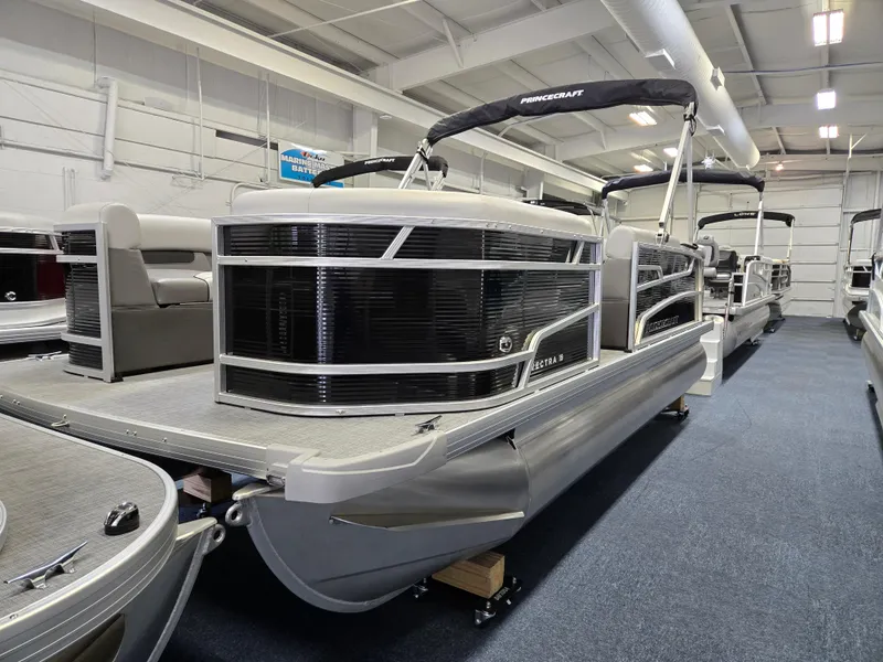 The Image of 2025 Princecraft Vectra 19 L pontoon boat in showroom, featuring sleek design and modern amenities. - 0