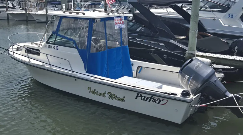 Slide: The Image of 1989 Parker 2310 Walkaround boat docked, "For Sale" sign, Yamaha outboard motor. - 1
