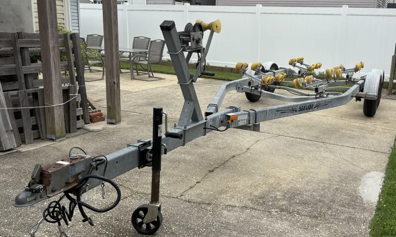 Slide: The Image of Boat trailer for 1989 Parker 2310 Walkaround, parked on concrete driveway. - 8