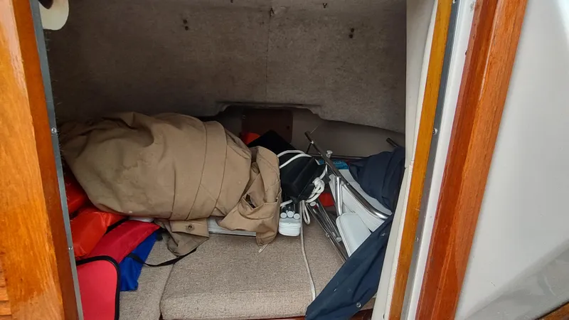 Slide: The Image of Cluttered cabin interior of a 1988 Shamrock 220 Predator boat with various items. - 14