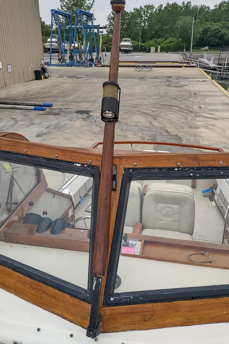 Slide: The Image of 1988 Shamrock 220 Predator boat with wooden trim and windshield, docked at a marina. - 17